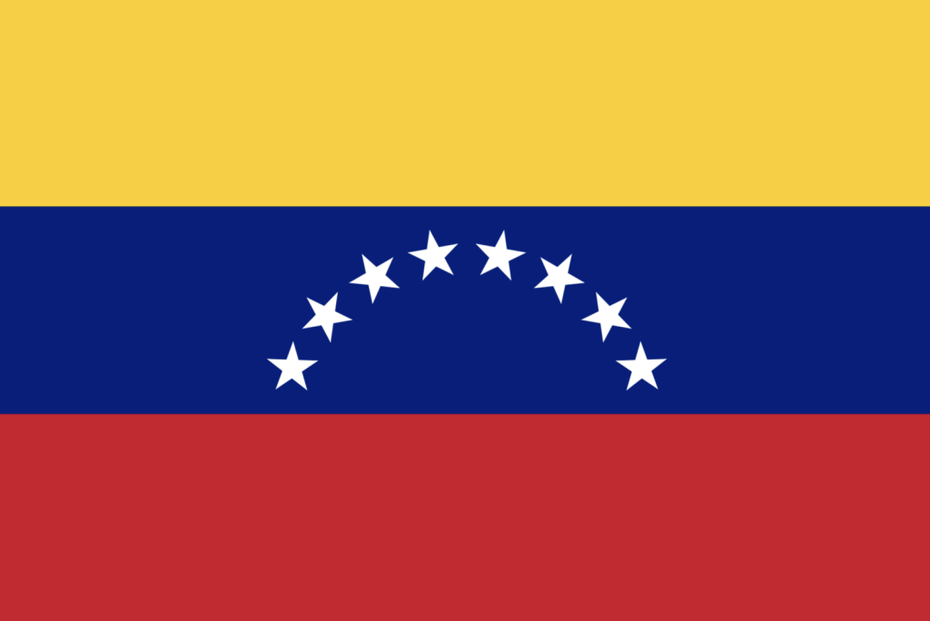 Bild på Venezuelas flagga gul, blå, röd och vita stjärnor på det blå.