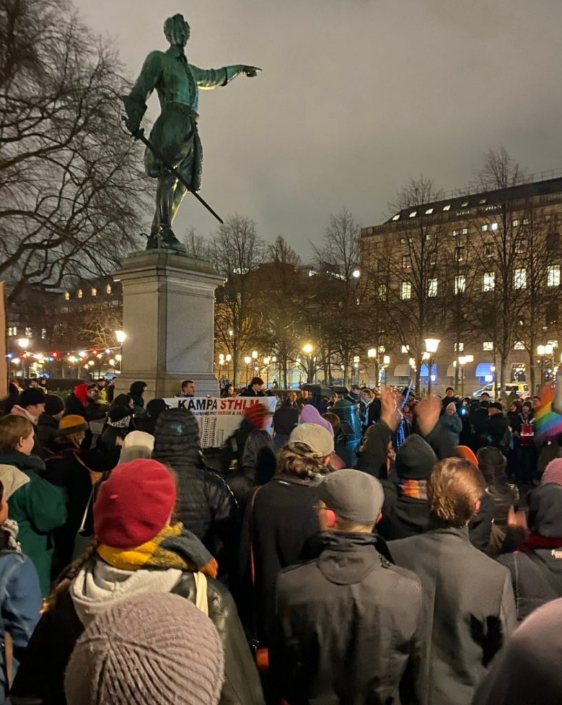 Bild på hundratals demonstranter runt statyn av Karl XII.
